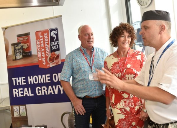 Janette Deyermond, owner and director of Comptons Gravy Salt, with Wilson Deyermond at the World Gravy Championships speaking to Carlisle College lecturer Sean Downes